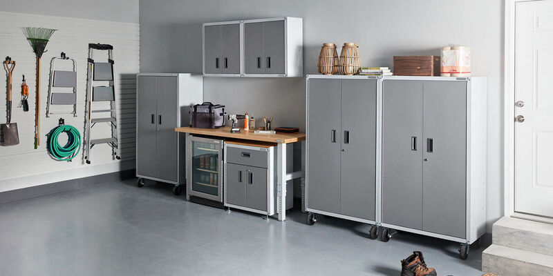Organized garage with tool chest and wall with storage hooks hung
