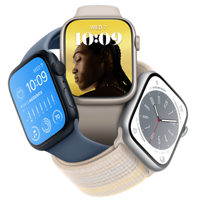 One green Apple Watch and one starlight Apple Watch overlapping