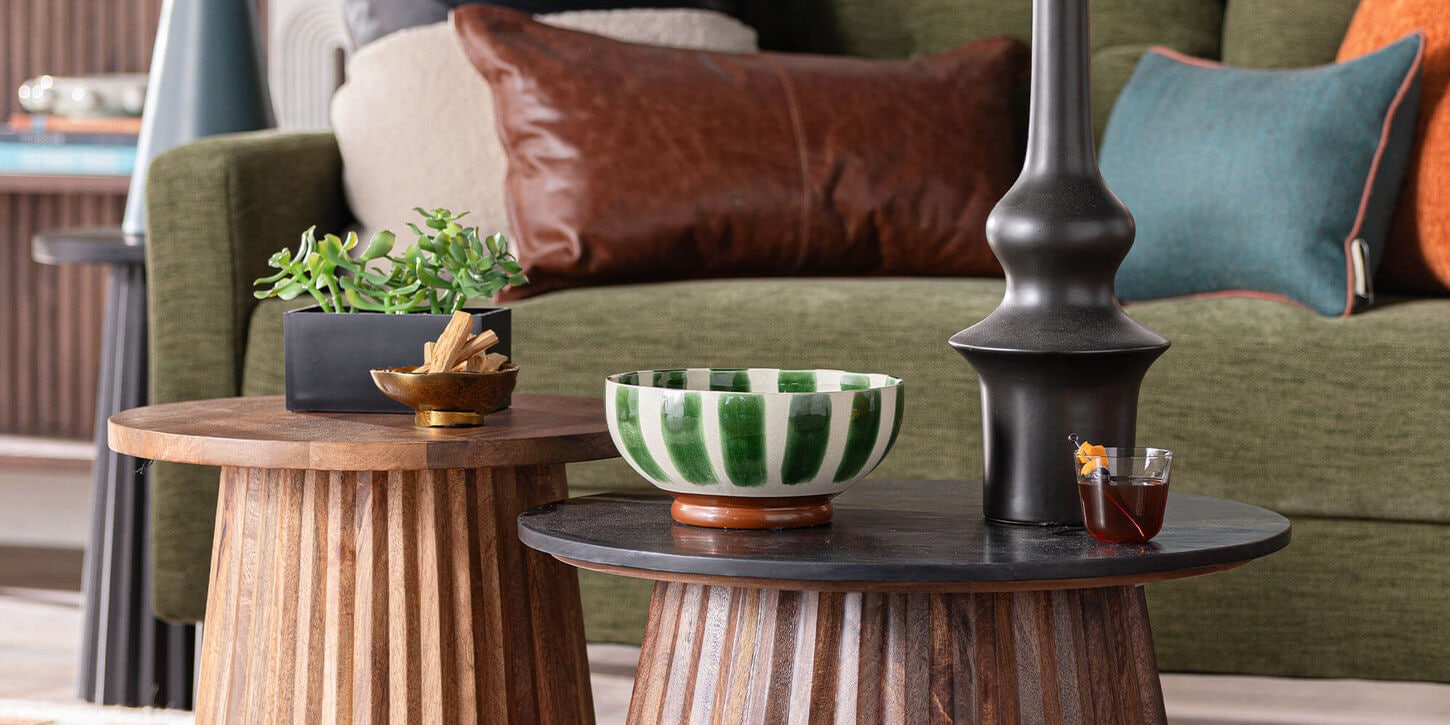 Green sofa with browns and earthy tones for organic origin trend.