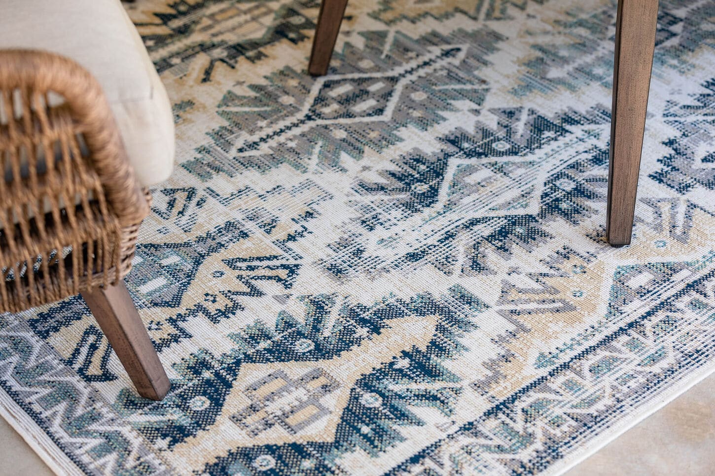Outdoor rugs layered together in a pile