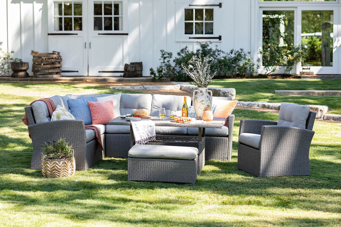 Outdoor sectional with food and wine on table
