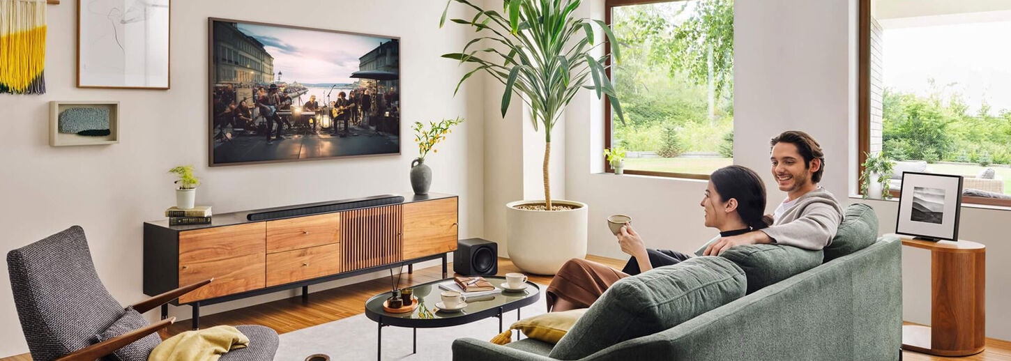 Couple watching TV in living room