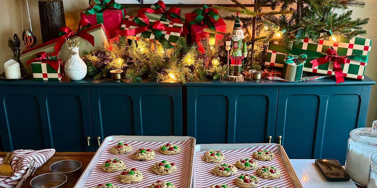 Cookies on counter and a long credenza filled with christmas decor