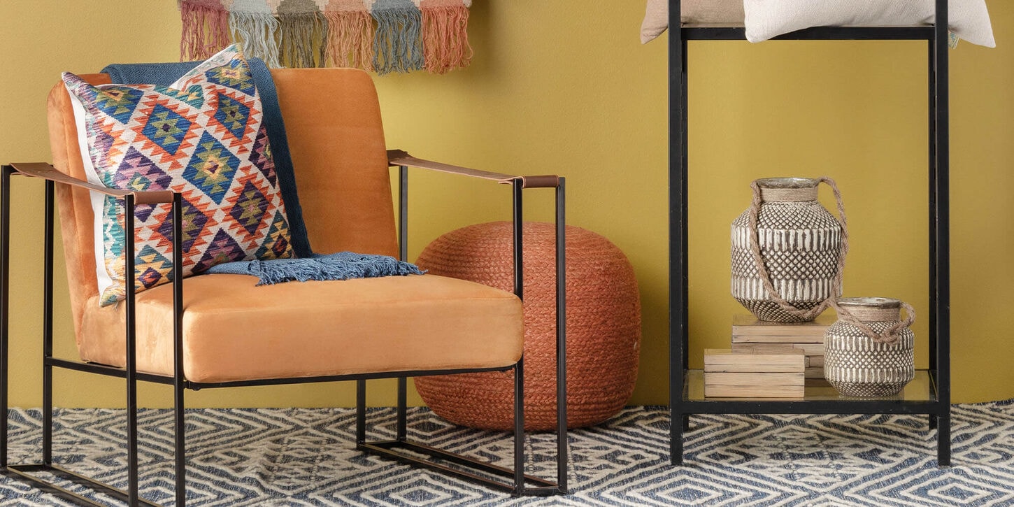 Rug with chair and throw pillow in a yellow room with lots of colors