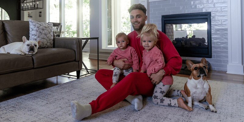 Gehrig Dieter with daughters and dogs in living room.