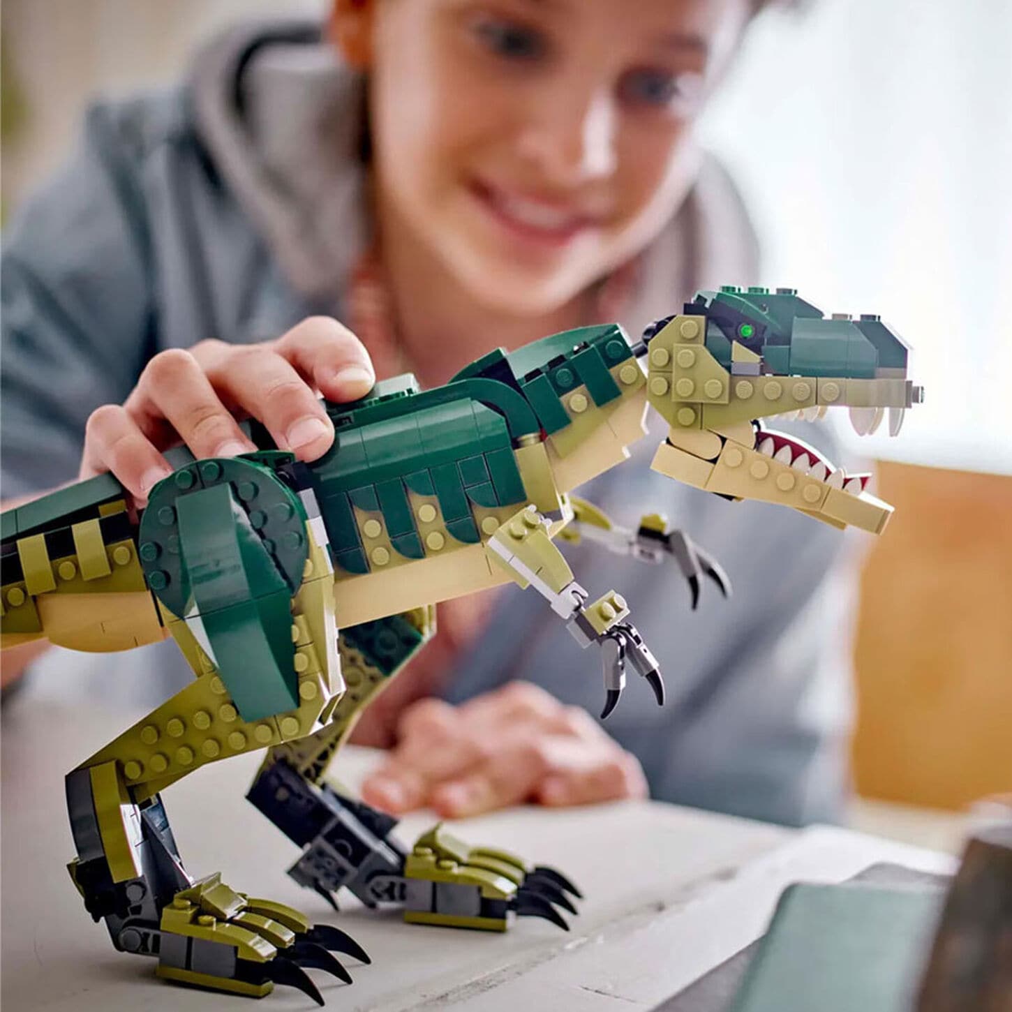 Man working on a laptop at a table with his cup of coffee