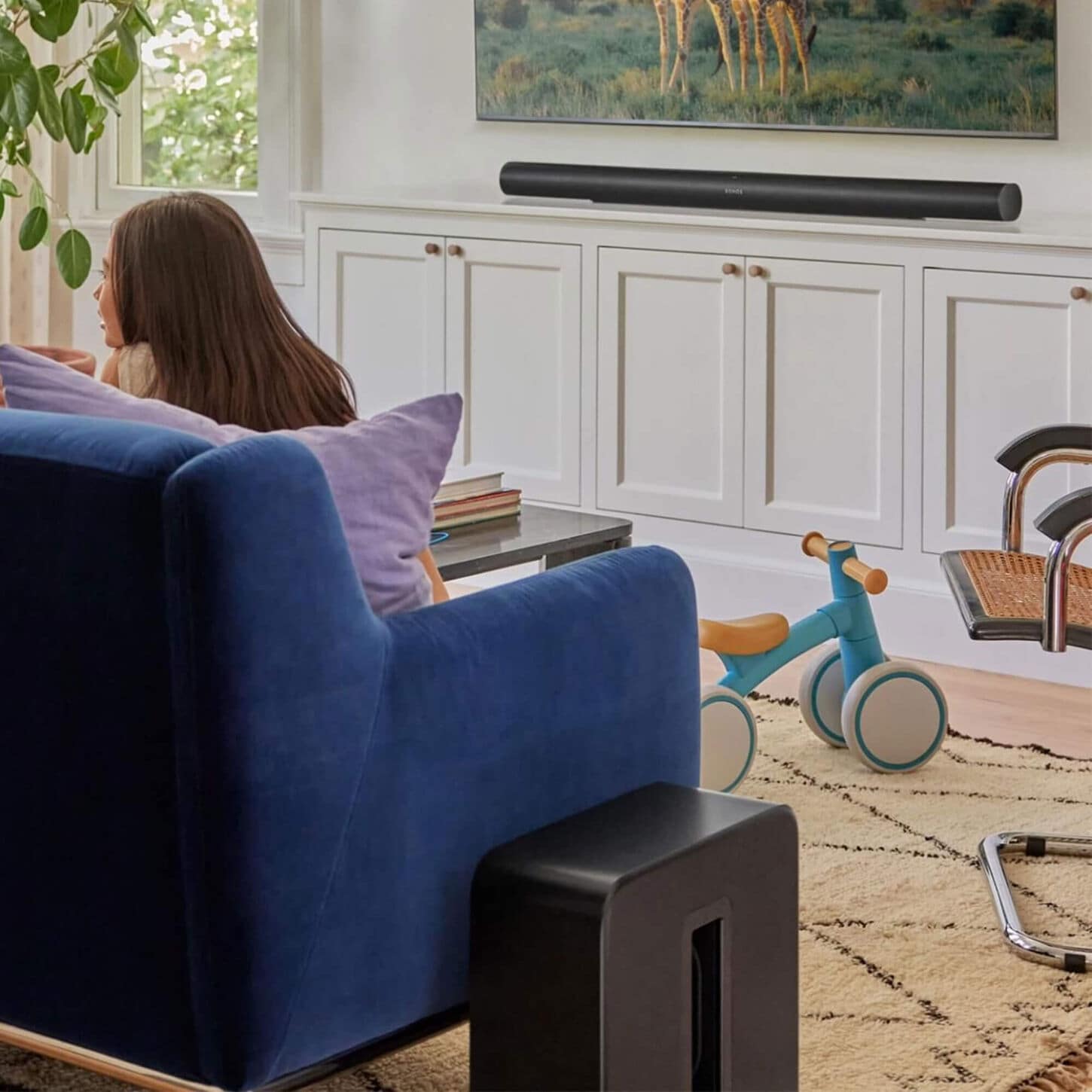 Person clicking button on a soundbar