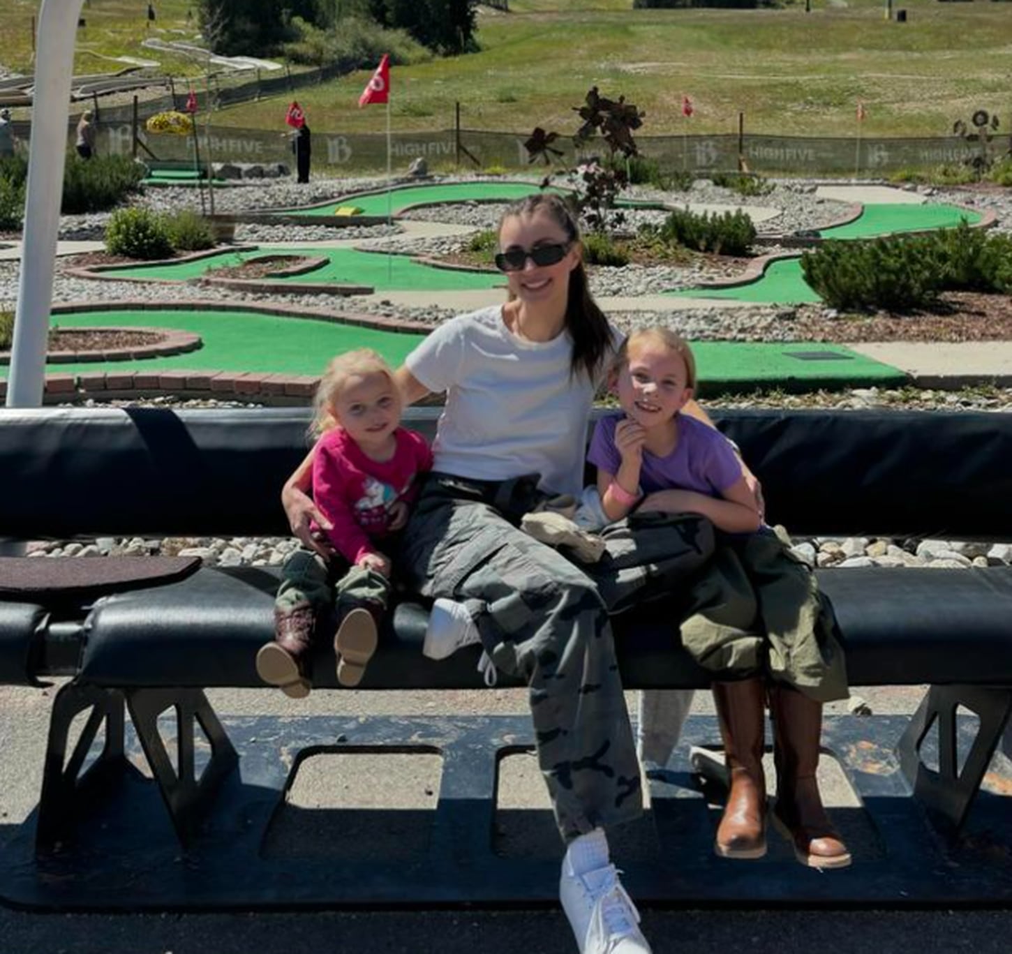 Megan with her kids at a putt putt place
