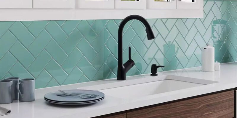 kitchen with white countetops bronze single handle faucet with green subway tile backsplash