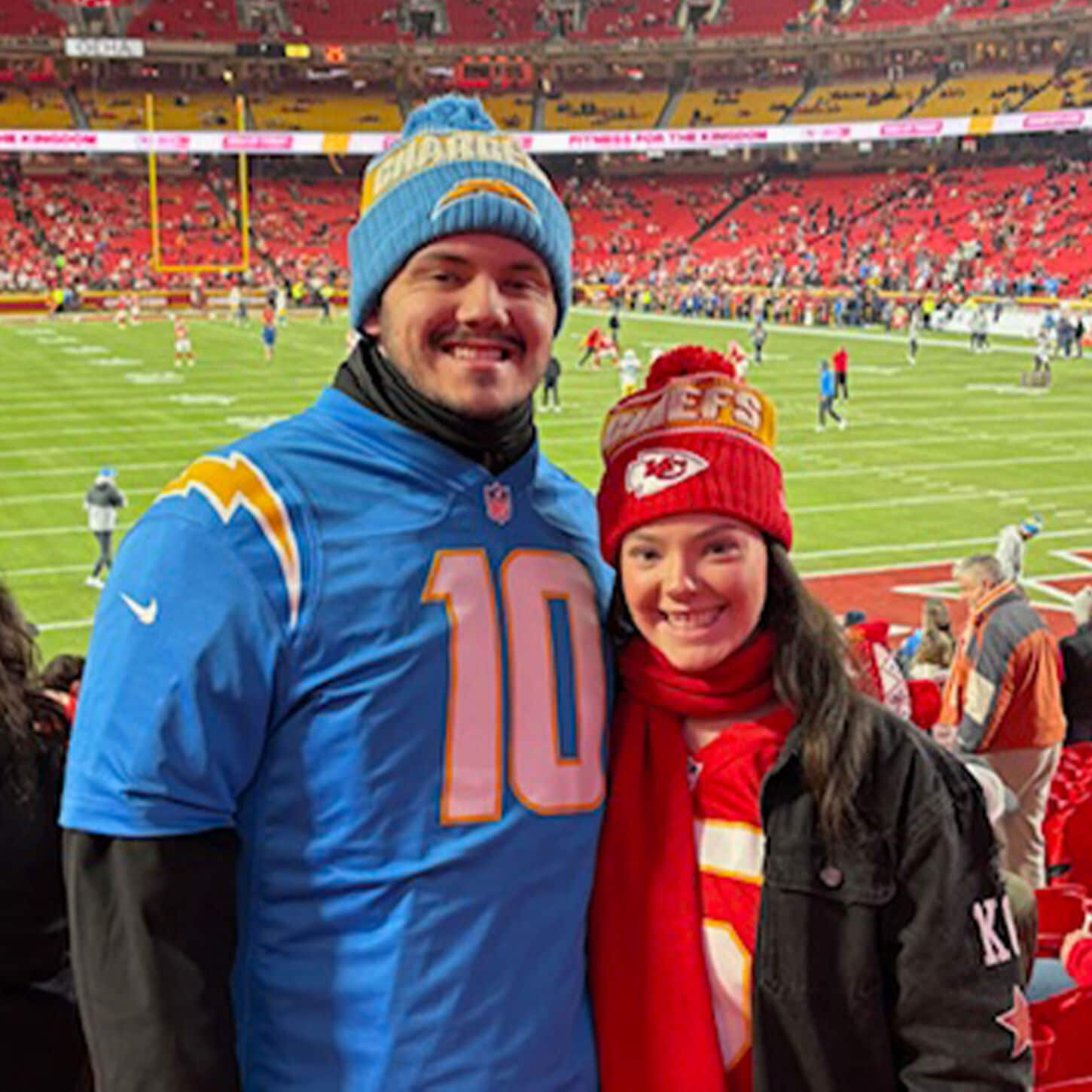 Ashley and Jonathan at an NFL football game cheering on different teams