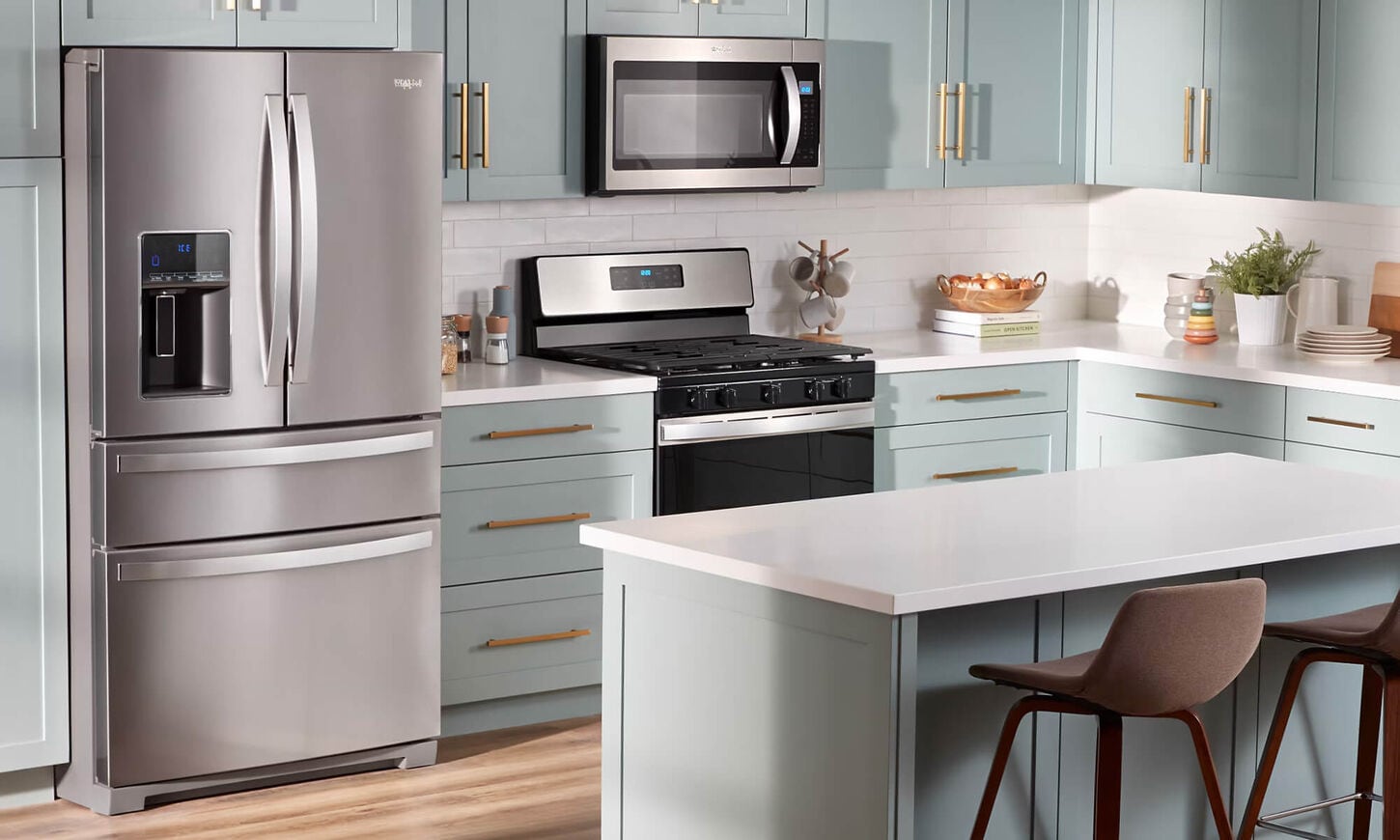 Kitchen appliances in a colorful kitchen with light teal cabinets