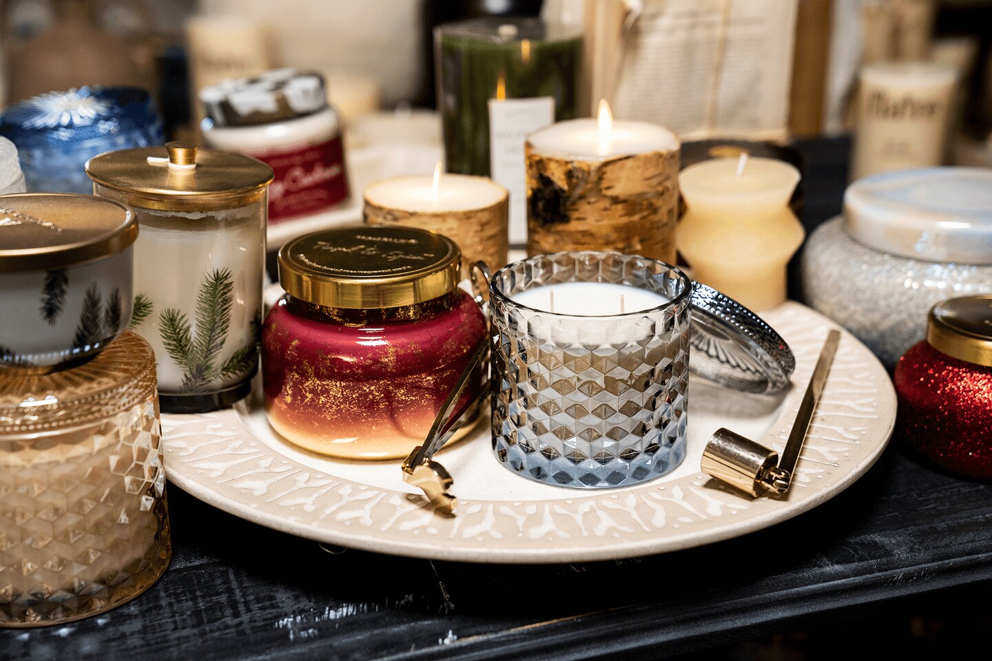 A bunch of glass candles that are different colors
