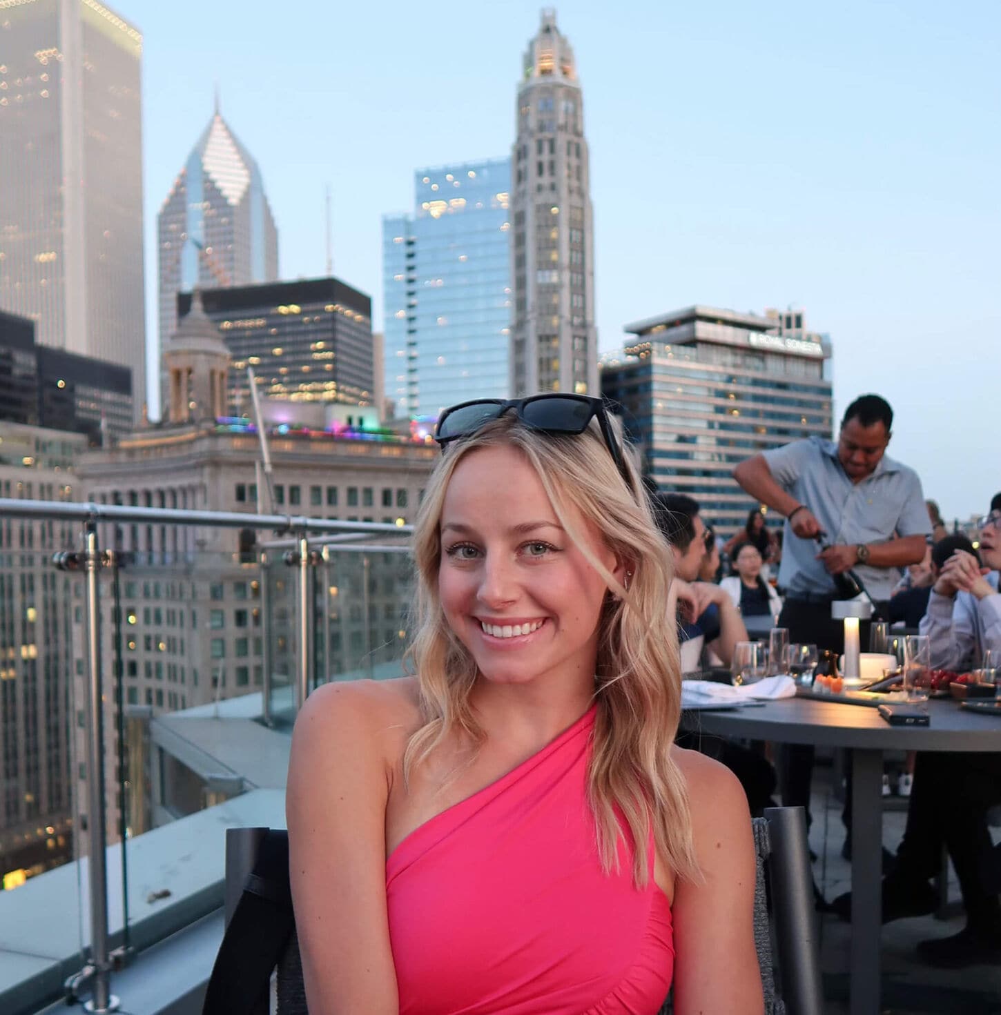 Ashley McElmurry sitting on a patio deck in front of a beautiful skyline