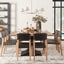 Brightly decorated dining room table with black dining chairs 
