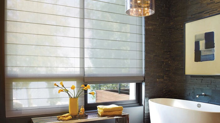 Living room with sectional with modern updated window treatments