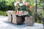 Outdoor eating dining tables with food on table and blue and white rug underneath