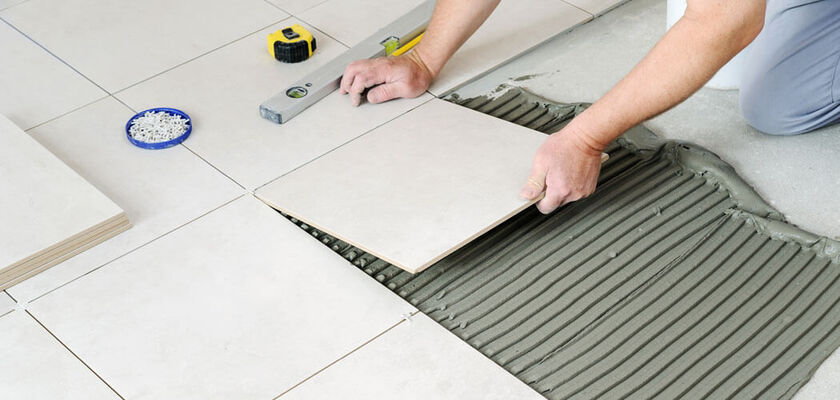 Man laying tile flooring