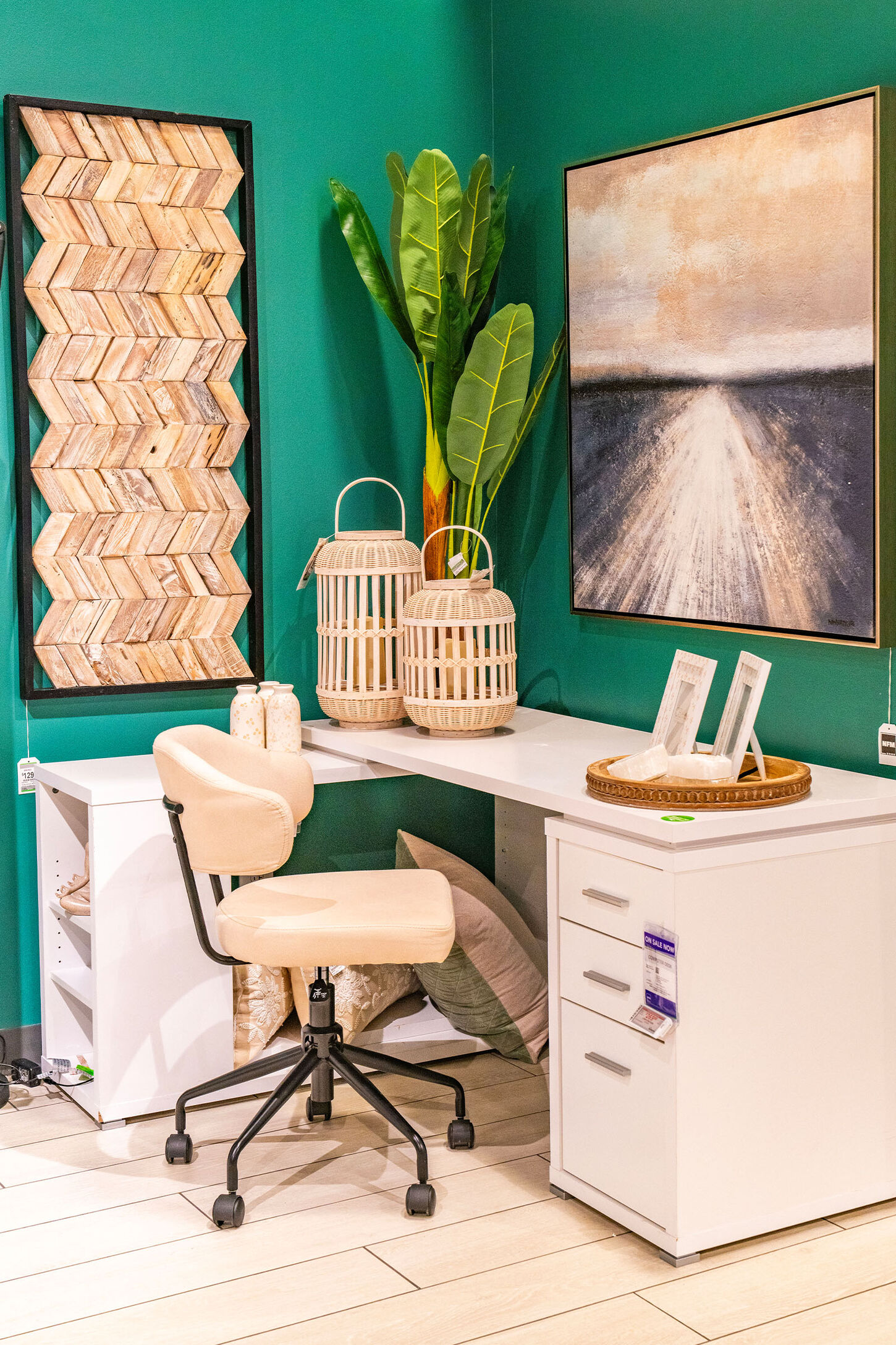 Small office space with white, chair, decor and artwork on the walls
