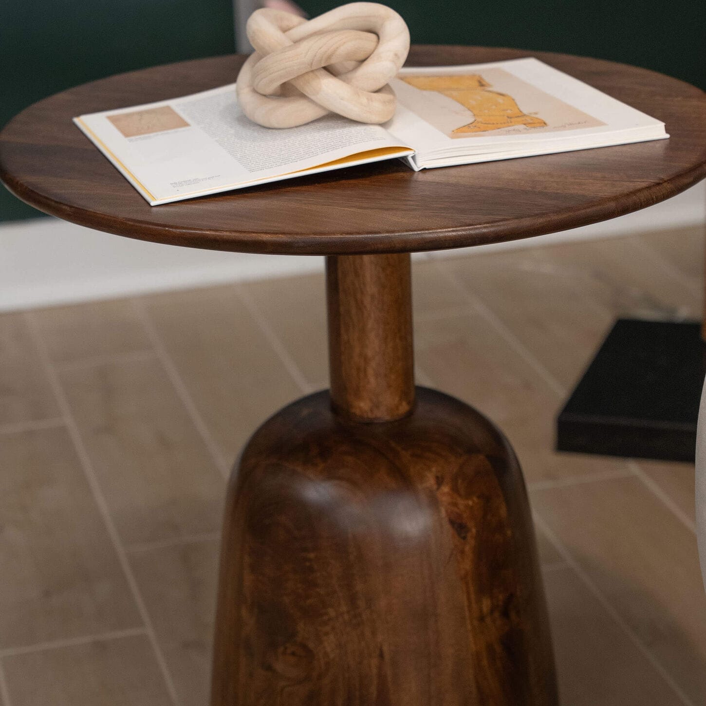 Small nesting table with a book and paper weight in the living room