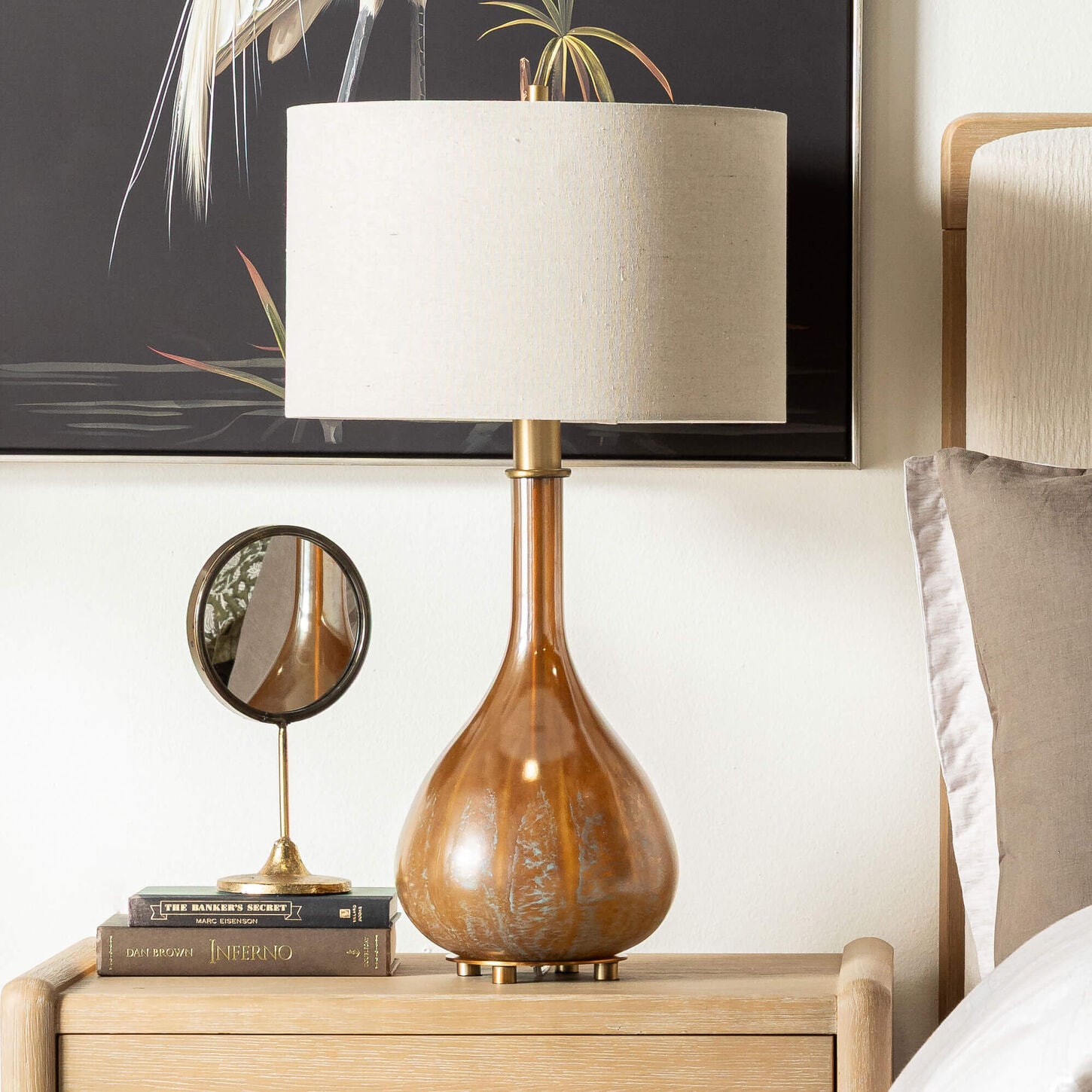 Brown lamp with white shade sitting on table