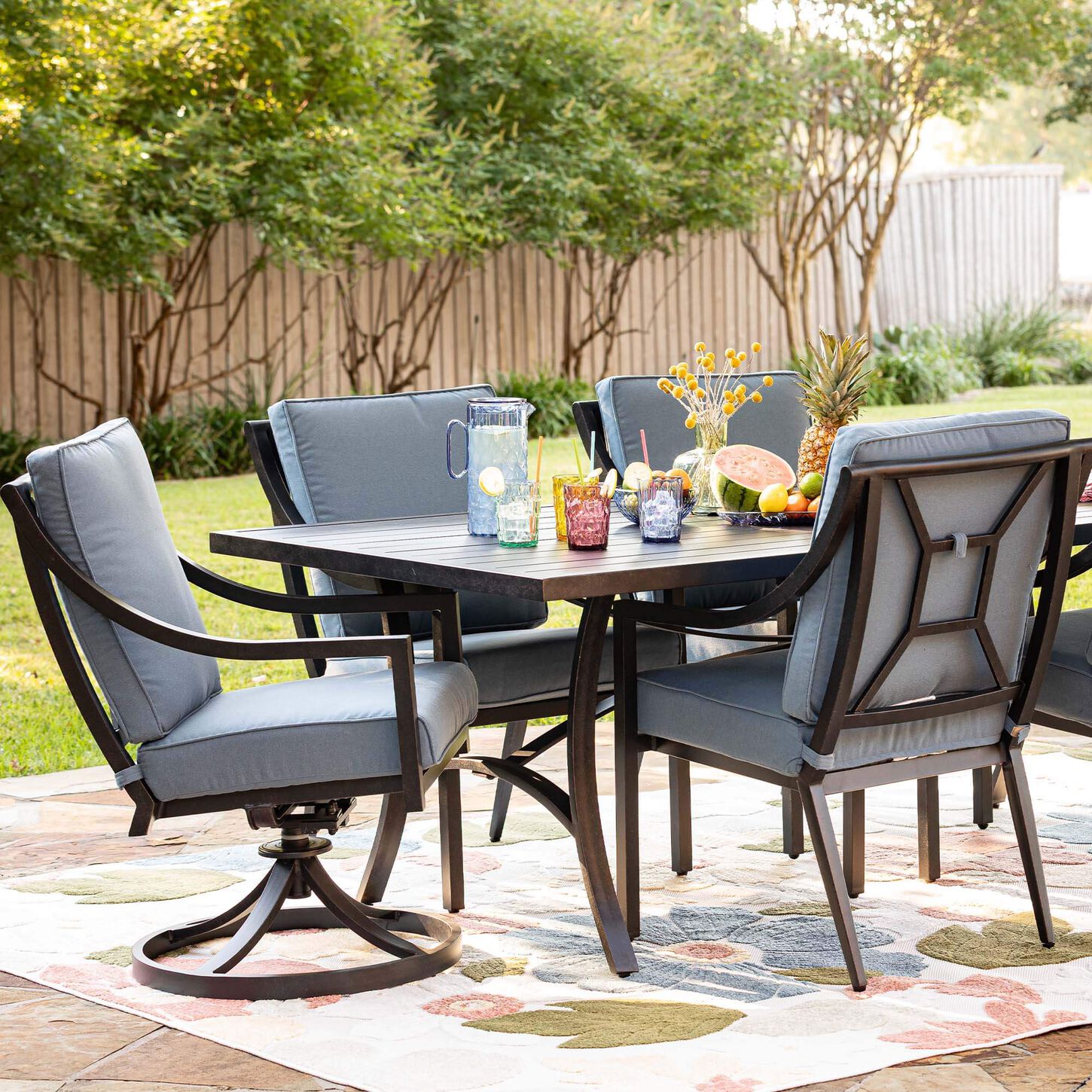 Decorated aluminum patio dining set with blue cushions