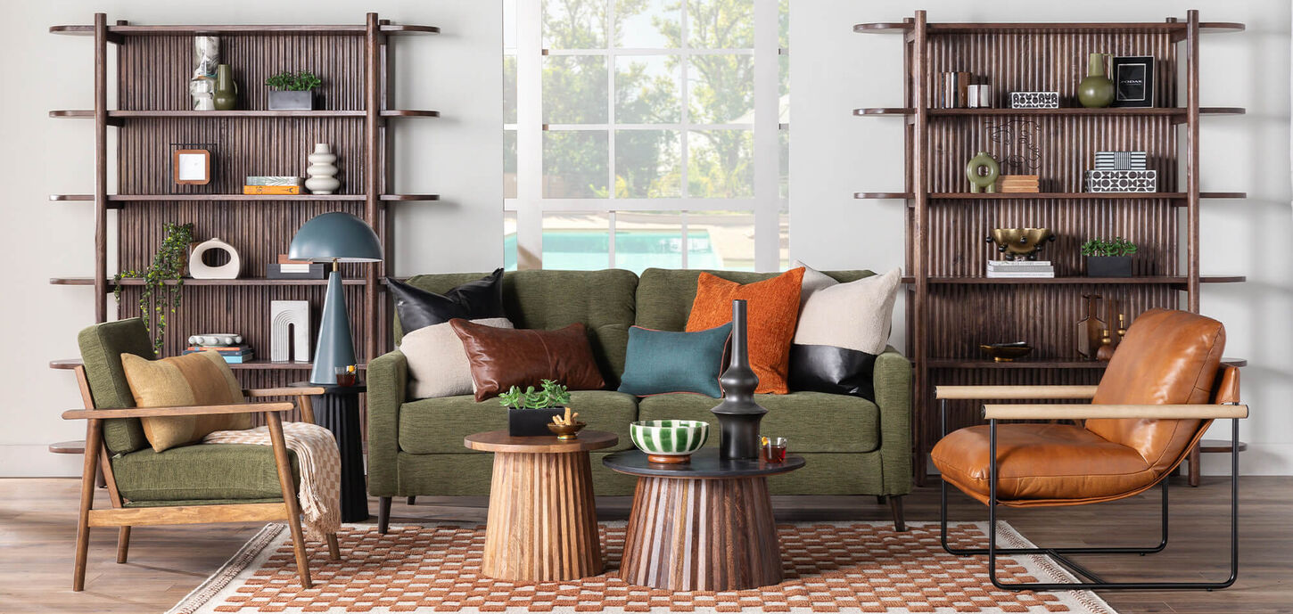 Brightly lit living room with green sofa and chairs