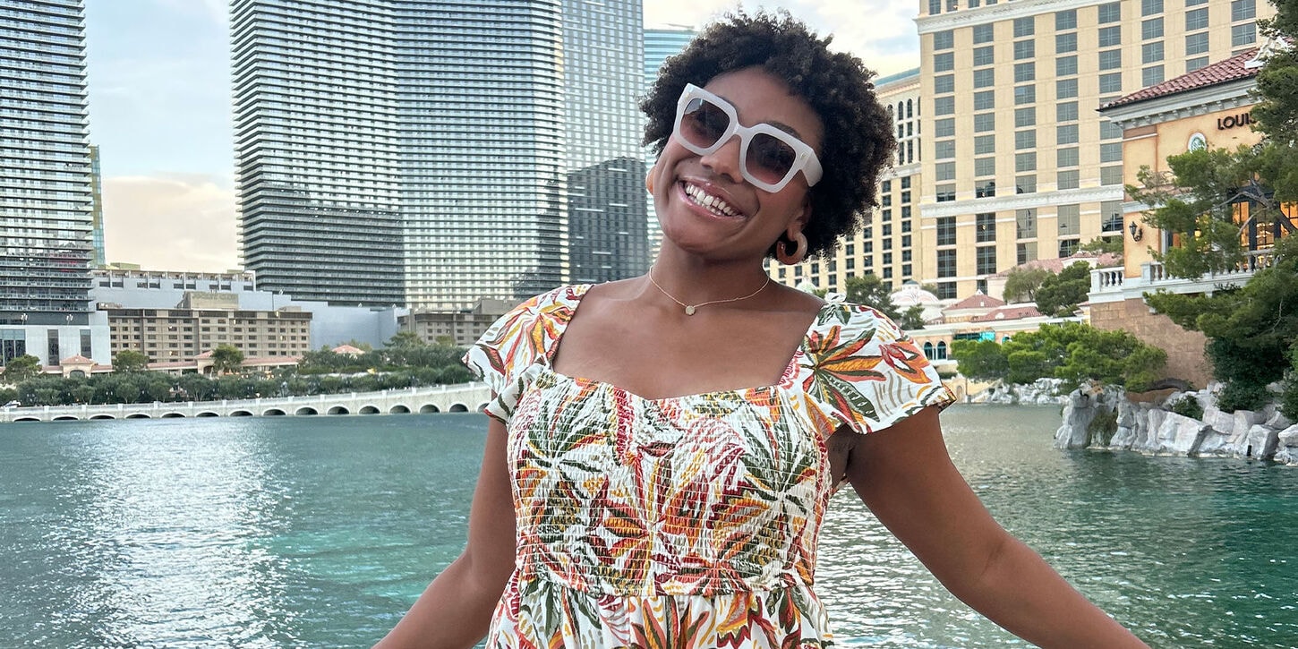 TyJanae Hooks standing in front of a body of water posing for the camera