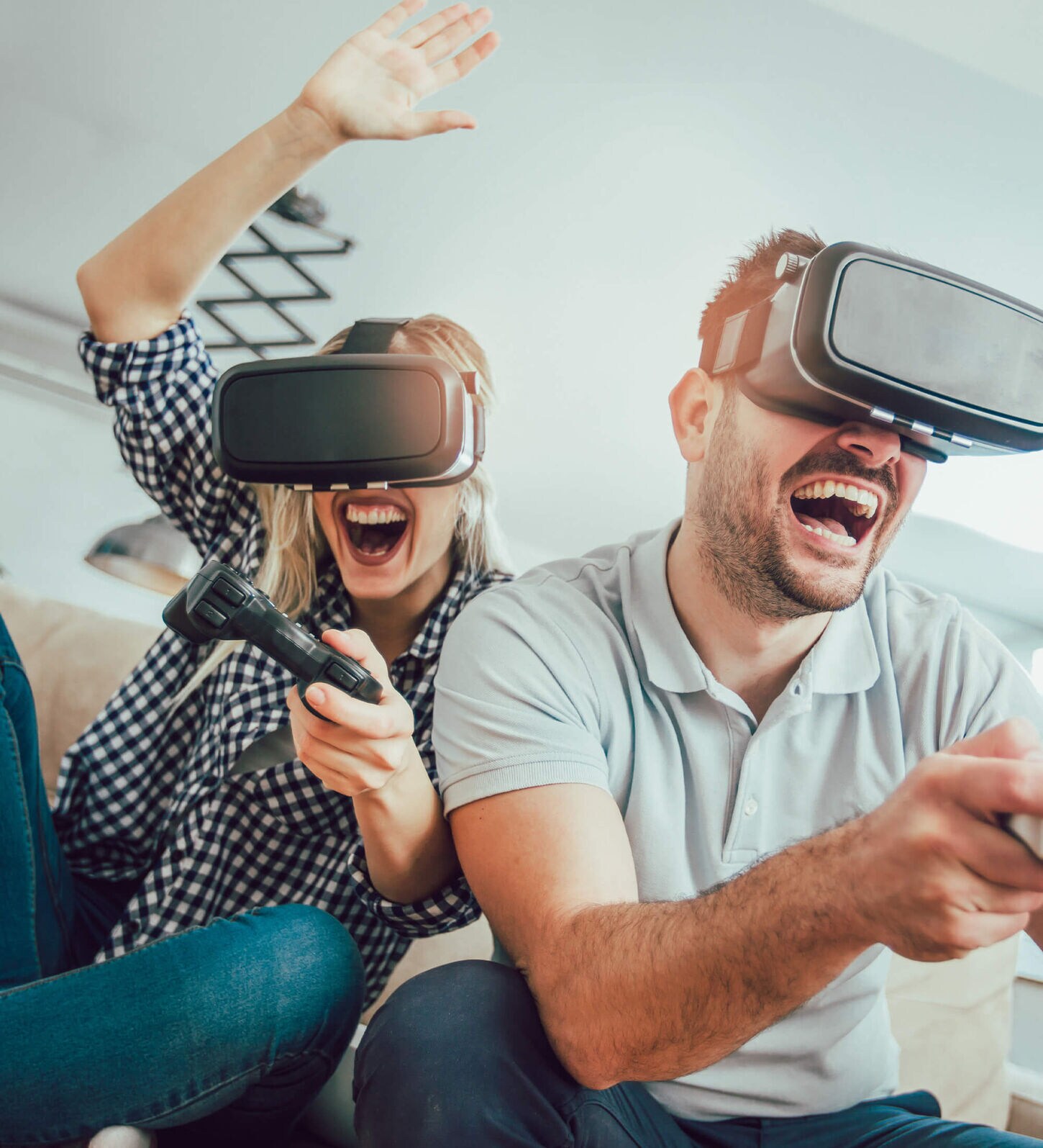 couple engaging in a virtual reality game on their sofa