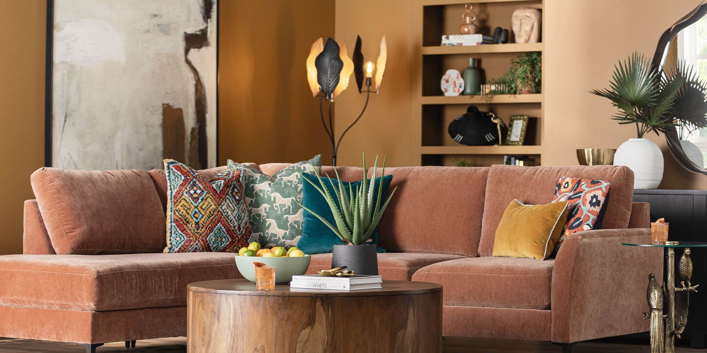 Living room with large lamp in the background behind the couch and decor
