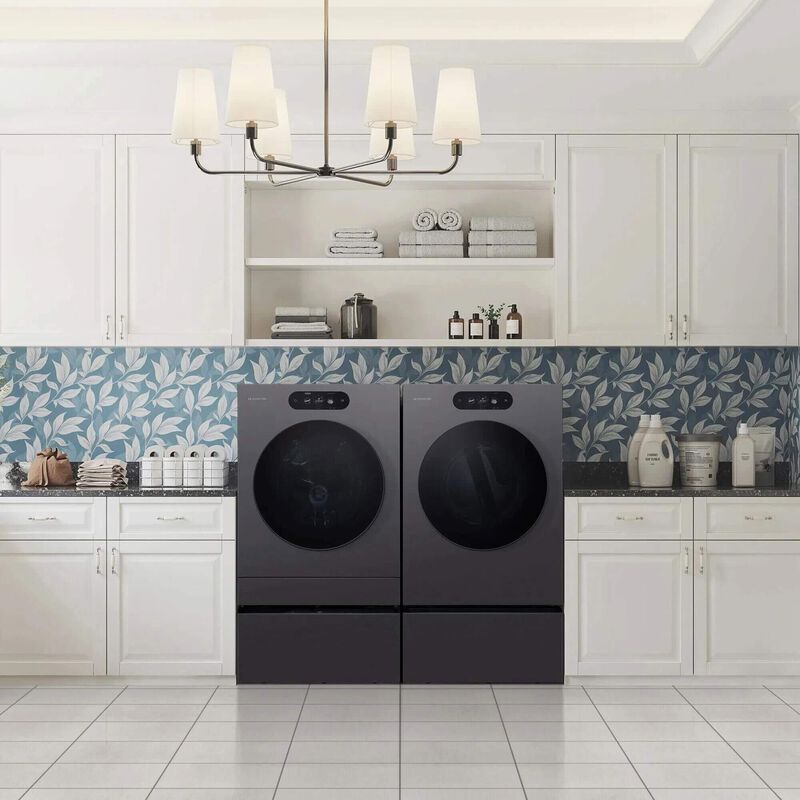 dark gray front load laundry pair in a room in between white cabinets