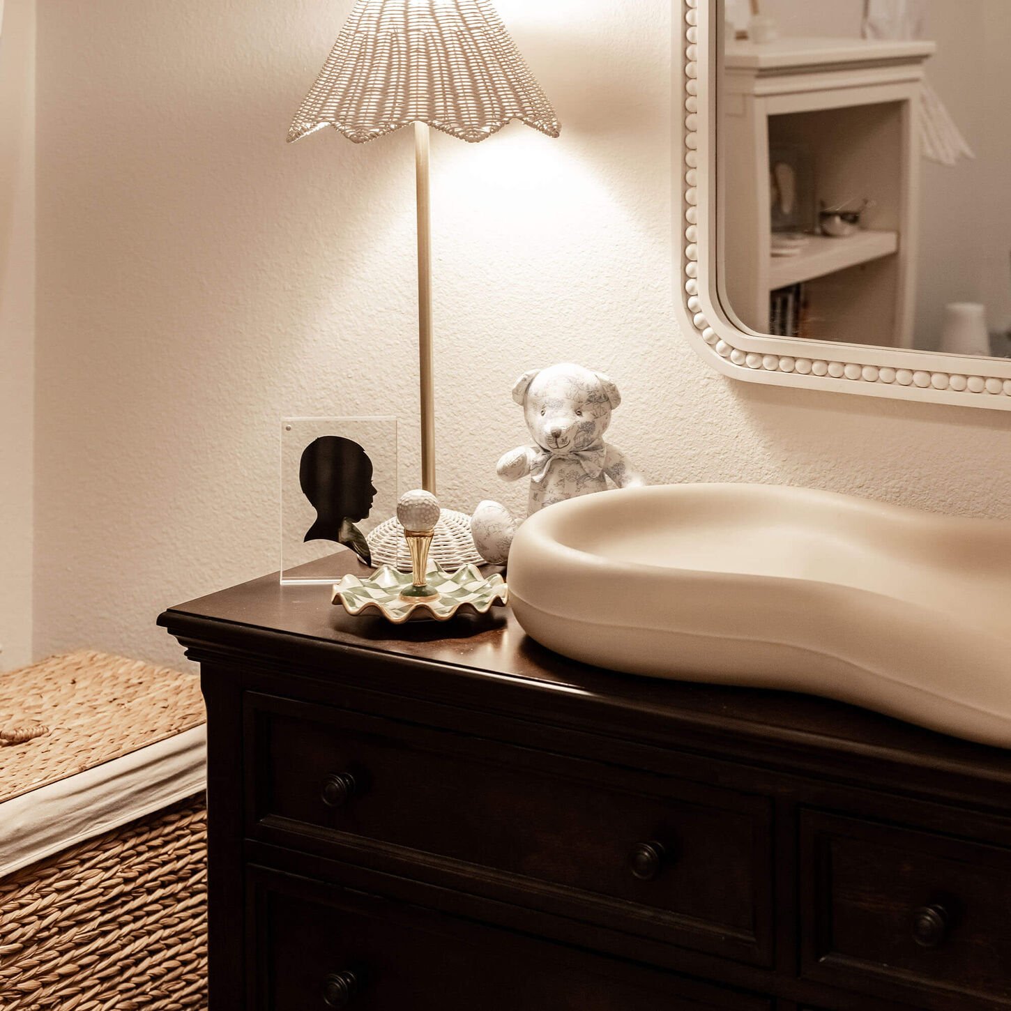 Shelby's nursery with her dresser, lamp and baby decor