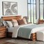 A bright bedroom with a woodgrain bed and nightstand