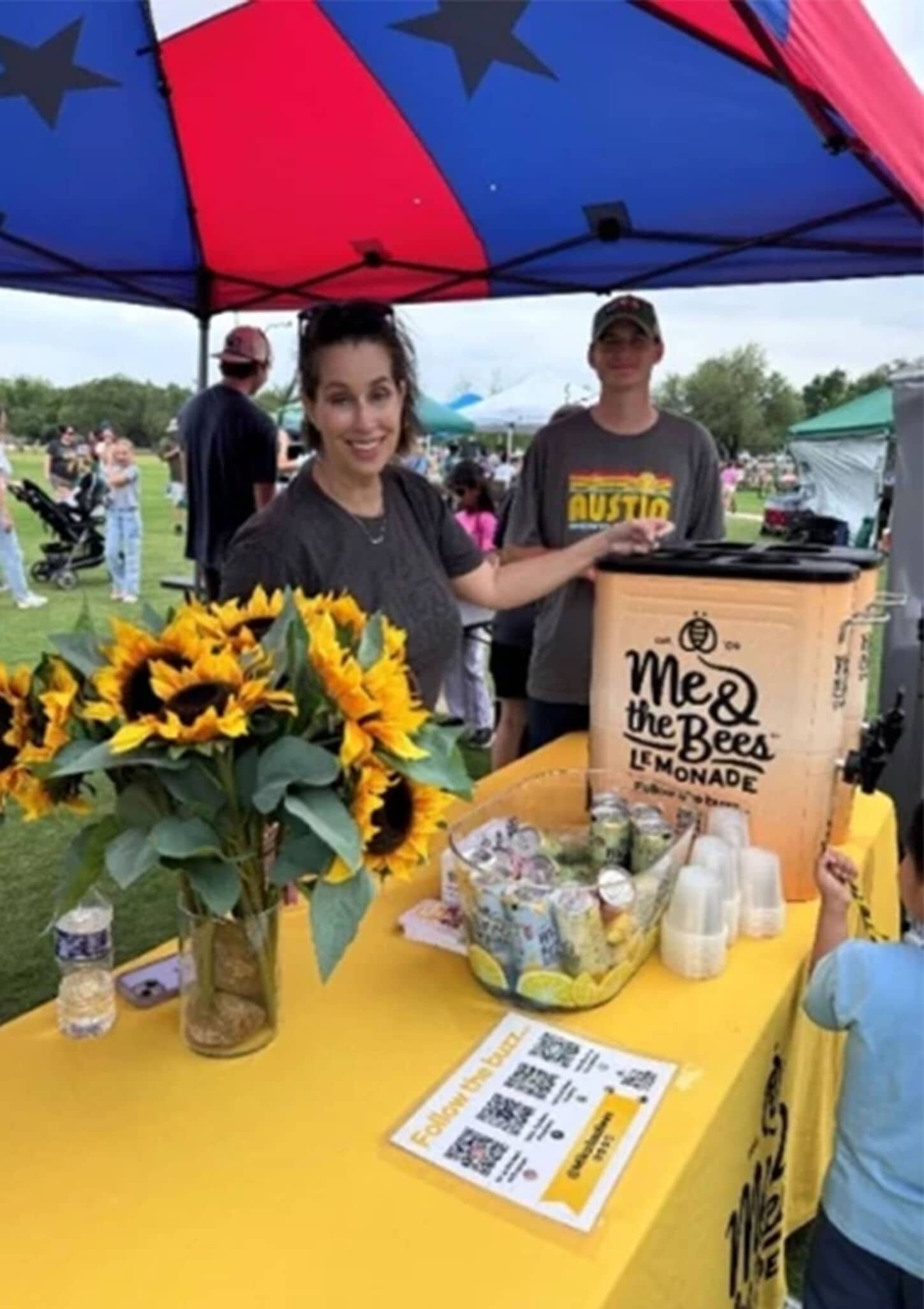 Cedar Park Earth Day event with women standing next to sunflowers