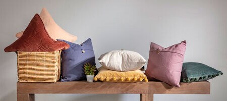 Variety of throw pillows on wooden bench