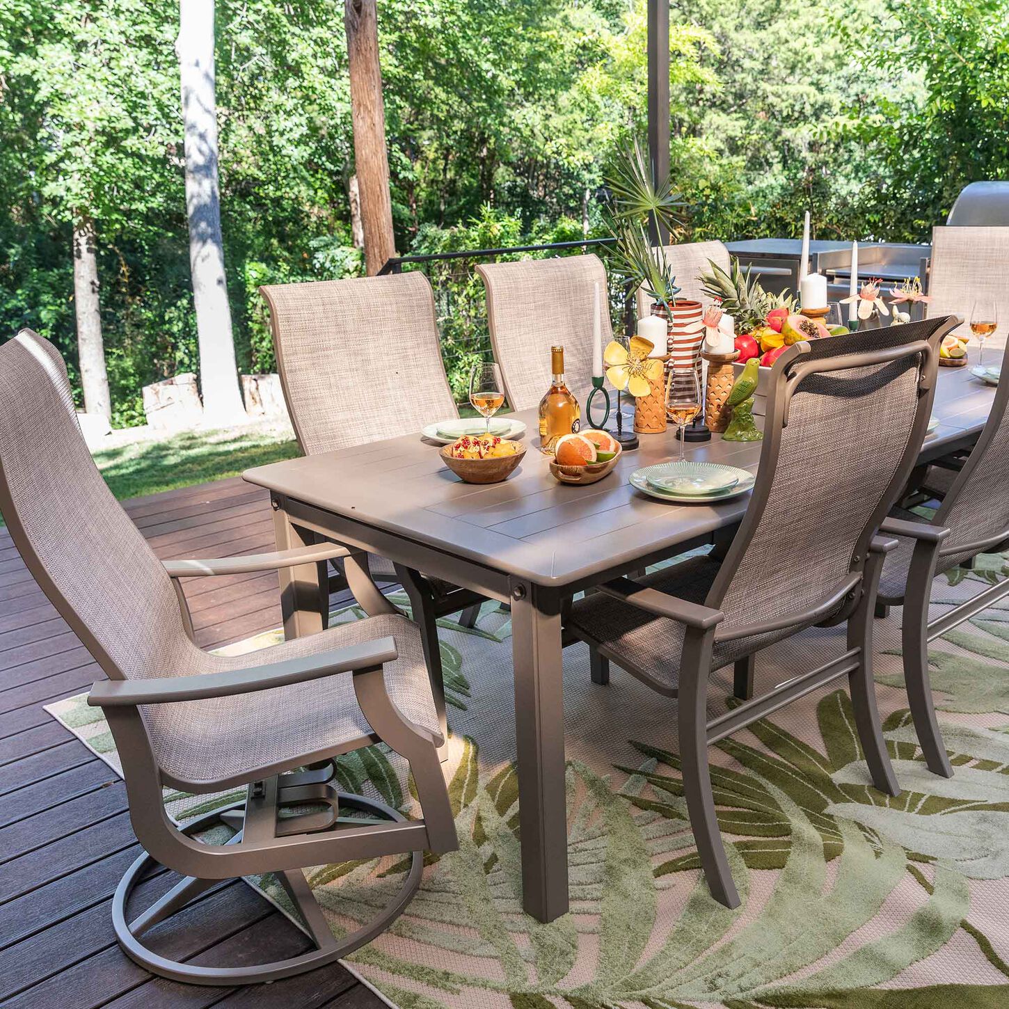 Patio Dining Set with 8 chairs and a table on deck with rug