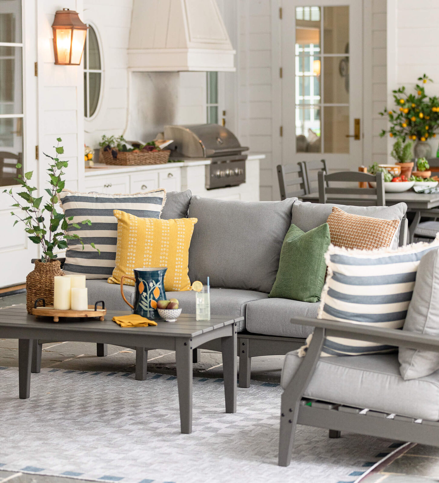 light gray 3-piece patio set that consists of a sofa, chair and coffee table