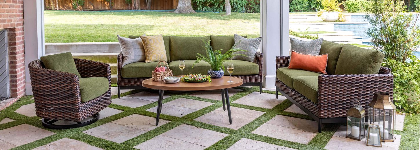 Wicker patio conversation set sitting under a covered patio