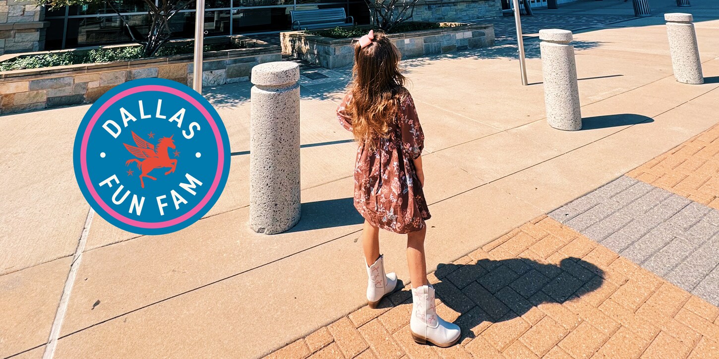 Dallas Fam Fun girl posing in front of NFM