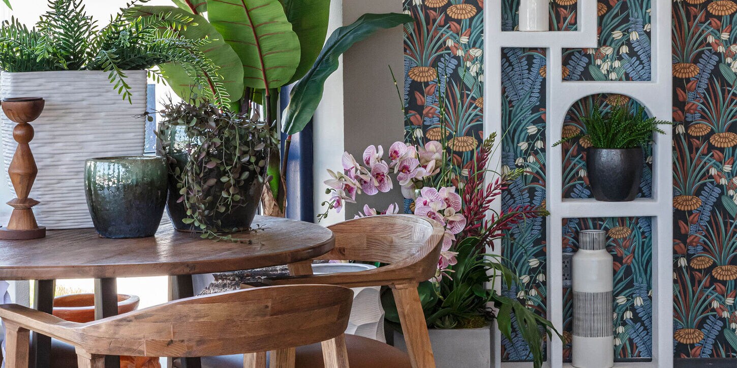 Green and blue colors and decor in a room with a dining table and shelf