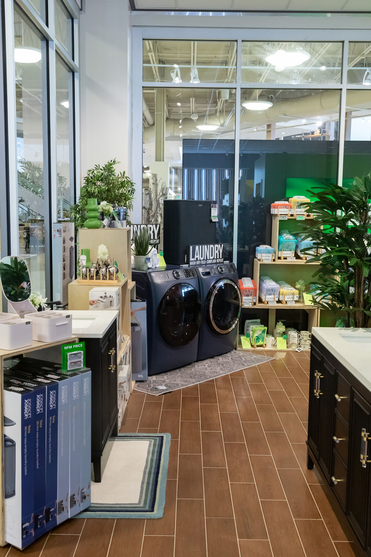 NFM popup shop inside the store displaying an eco-friendly washer and dryer combo, along with a variety of other sustainable products sold in the store