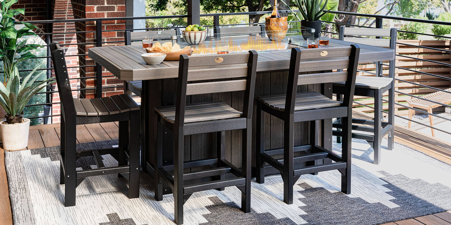 Backyard patio furniture and string lights hanging across the yard