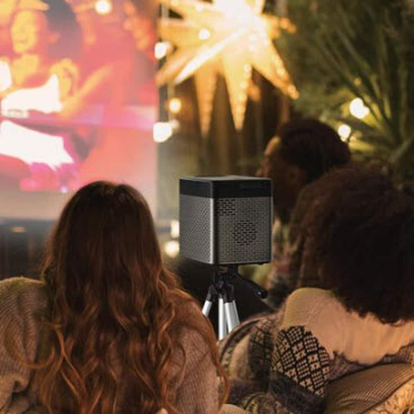 Small outdoor projector playing a movie