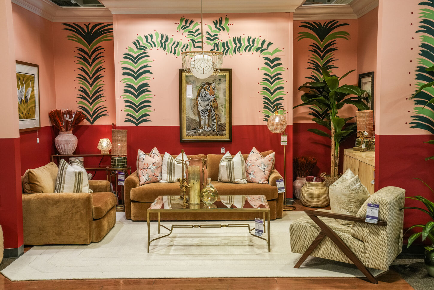 Two modern paintings stacked next to each other sitting on a credenza