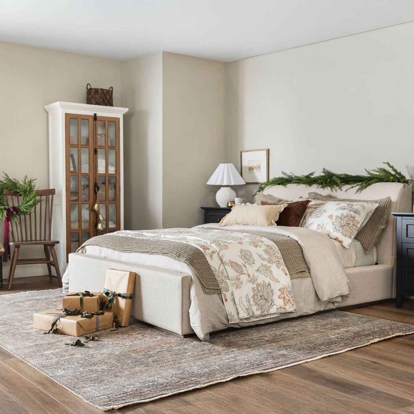 Bedroom scene with bed and holiday garland