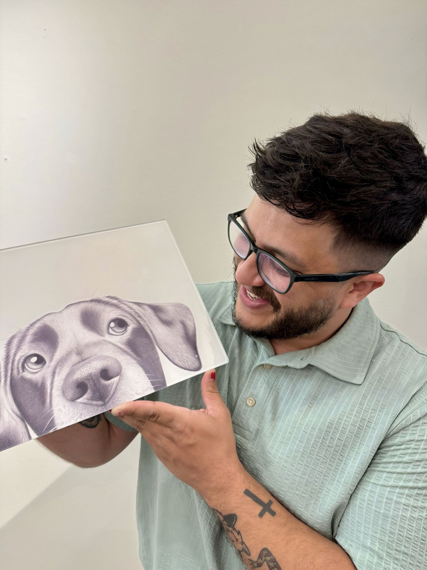 Bryan holding a painting on a dog up