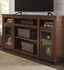 Living room with TV sitting on Ashley Harpan 72" TV Stand in Reddish Brown