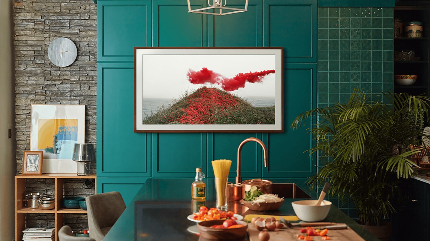 A fun and bold teal kitchen with a Samsung tv art framed.
