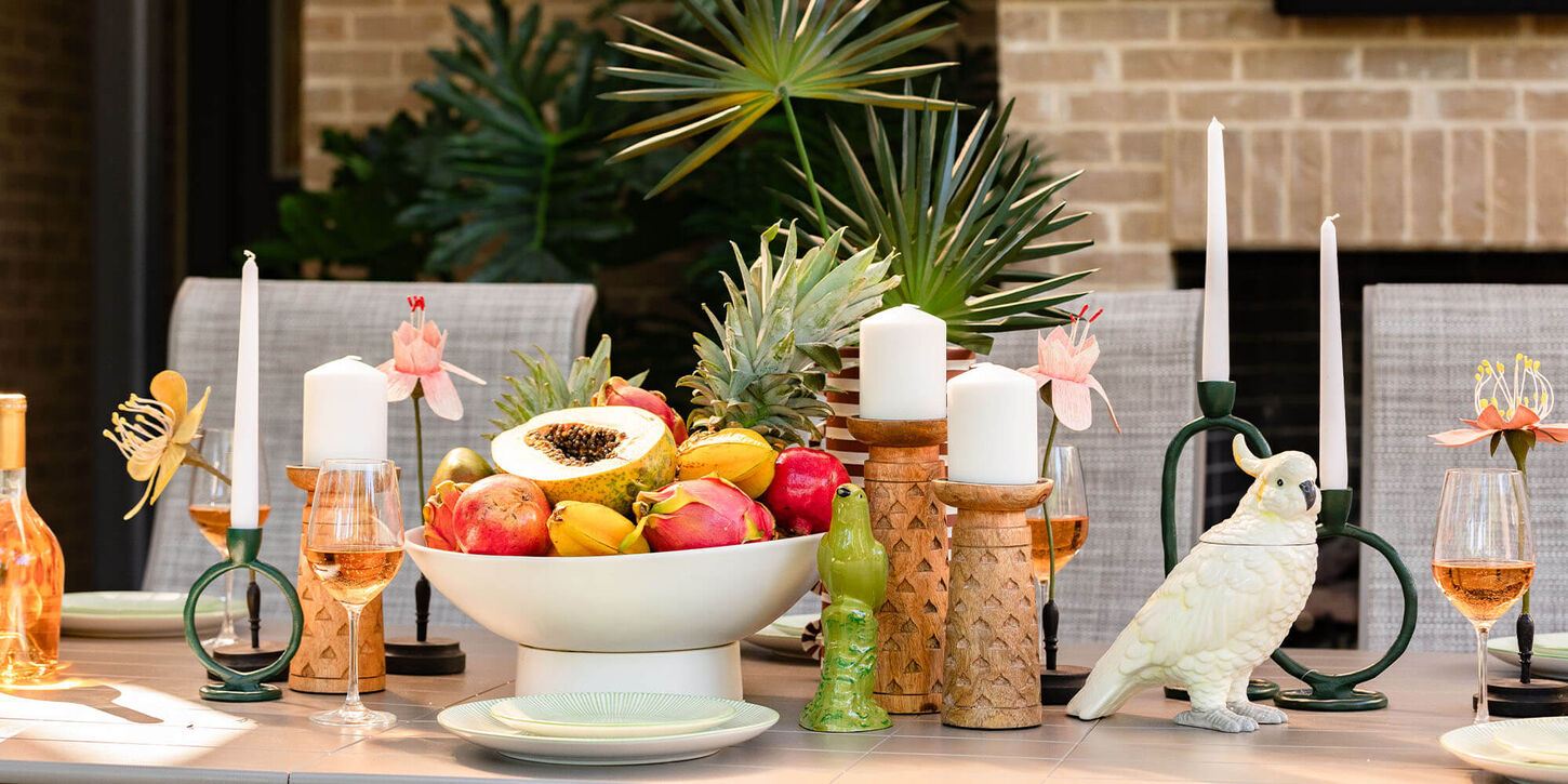 Outdoor patio furniture with a dining table, chairs, and a large area rug