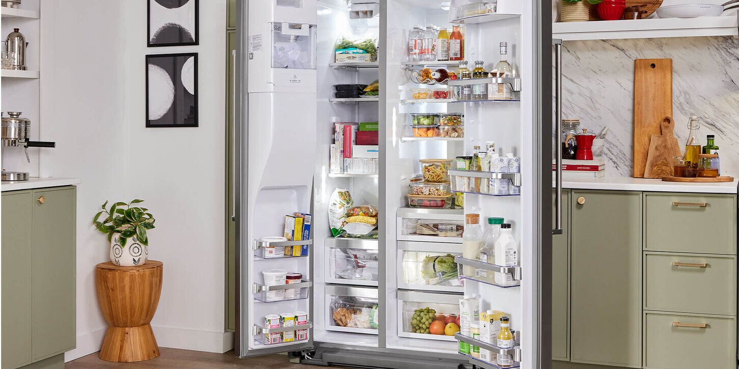 Kitchen refrigerator full of food with a decorated kitchen