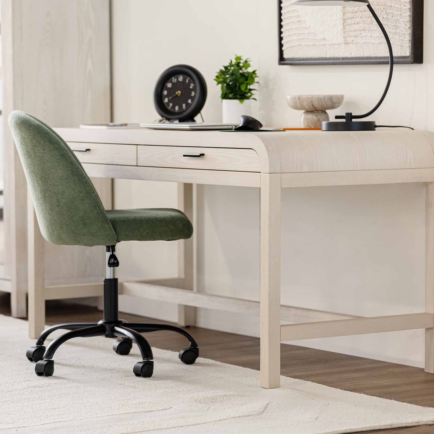 light wood desk with green office chair